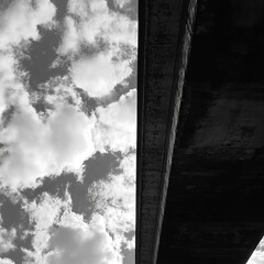 Grey concrete overpass under a cloudy sky