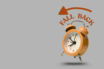 Orange clock with white face and black numbers