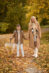 mother and son playing in the autumn park