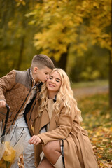 Fototapeta premium mother and son playing in the autumn park