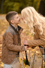 mother and son playing in the autumn park