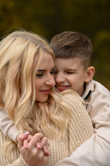 Fototapeta premium mother and son playing in the autumn park