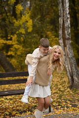 Fototapeta premium mother and son playing in the autumn park