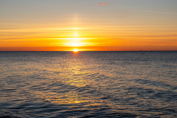 Beautiful sunset over the beach in Prerow on the Baltic Sea with golden light calm waves and peaceful coastal scenery