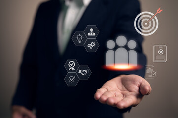 Businessman presents a holistic business management strategy. The interface shows icons for team leadership, quality assurance, goal setting, and strategic partnerships, symbolizing corporate success.
