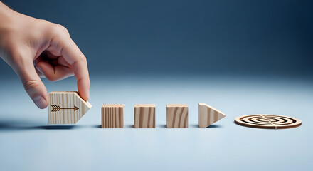 Hand places arrow block setting clear direction towards business goals