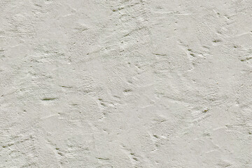Texture of rough, hand troweled white plaster or stucco with an uneven, bumpy surface. This bright wall background is ideal for architectural and minimal design.