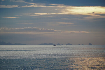 Panoramic sunset beach landscape in Thailand. Sunset sky calmness tranquil relaxing sunlight summer mood. Silhouette of fishing boat at sunset over the sea