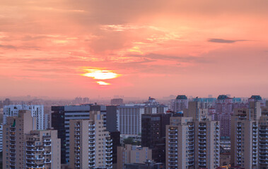 Obraz premium Aerail View of Gurgaon,Haryana,India at sunset.Gurugram city skyline with urban,modern architecture,design. Luxury residential apartments,commercial buildings of HNI in Delhi NCR.