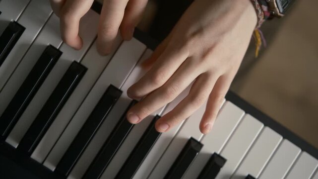 op view, girls hands playing synthesizer at home,  piano music lessons, close up 4k