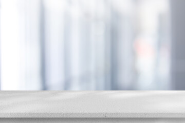 Abstract blurred interior modern office room background with perspective white cement table for...