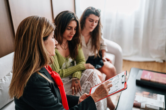 Real estate agent consulting couple during apartment property visit