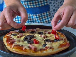pizza chef preparing hot pepperoni pizza