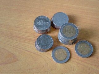Coins or Thai Baht coins, close-up rows of money coins on desk 