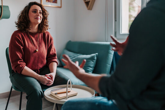Woman listening during therapy session in modern office