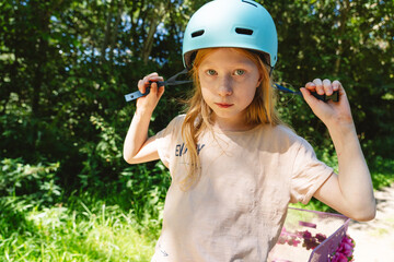 Girl with helmet outdoors showing decisiveness and curiosity