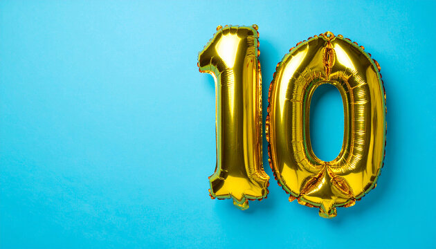 Gold foil balloon in shape of number 10 on blue backdrop, festive and celebratory mood