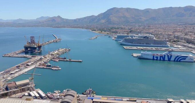 Aerial view of the port of Palermo, Sicily, Italy. There are many boats, ferries, and cruise ships in the harbor.