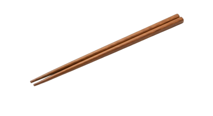 Pair of smooth, brown wooden chopsticks diagonally centered on a stark black background