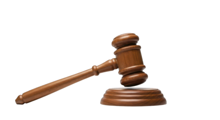 Wooden gavel rests, partially isolated against a stark black background