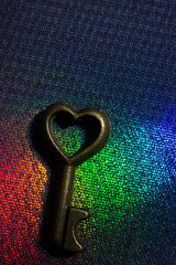 Vintage key. .Antique key. Retro key with a heart shape on  on colorful fabric