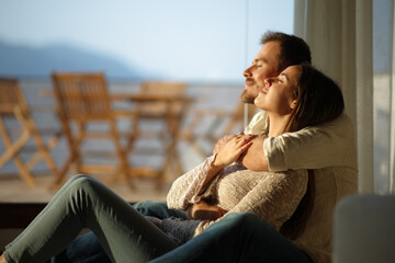 Happy couple in love hugging and relaxing at home