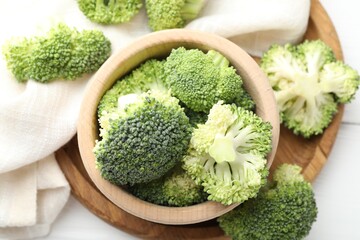 Fresh raw broccoli in bowl on table, top view