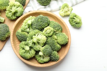 Fresh green broccoli on white wooden table, flat lay. Space for text
