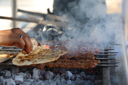 grilling adana kebap which is made from minced lamb meat