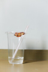close up of used empty plastic cup with straw