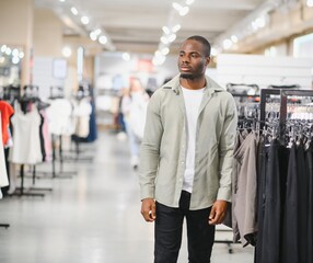 Fototapeta premium Stylish man choosing clothes in fashion store