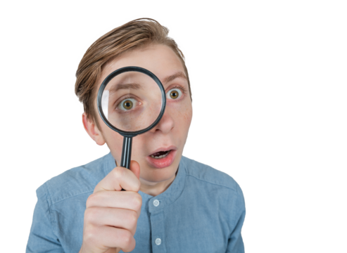 Curious teenage guy seeking for solutions as uses a magnifying glass. Male adolescent looks through the magnifier and searching, portrait isolated on transparent background
