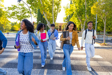 Diverse students walking across crosswalk on university campus