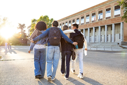 Diverse students walking to university campus together - Powered by Adobe