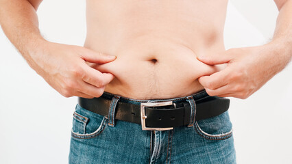 Man Pinching Belly Fat. Close-up of a man's abdomen.