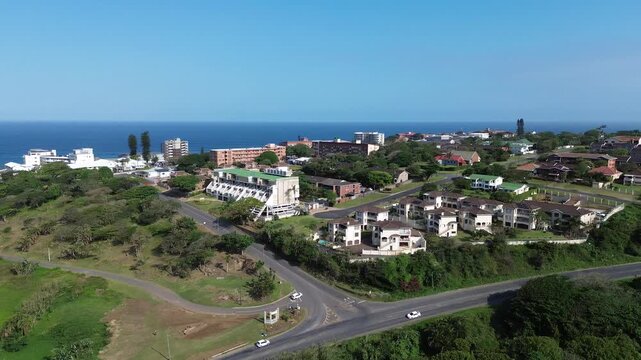 Camera panning from Scottburgh to Umkomaas coastal towns with the sea in the background and the South coast of KwaZulu-Natal stretching to the horizon 4K Aerial Video.