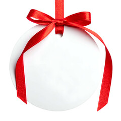 A blank, white circular tag hangs by a red ribbon and bow against a transparent background