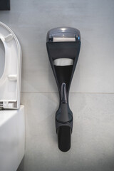 Black duo dispenser for toilet paper and brush