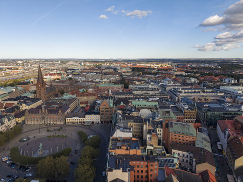 Aerial view of Stortorget Square's vibrant blend of historic architecture and modern urban life unfolds under a vast sky, Malmo, Sweden.