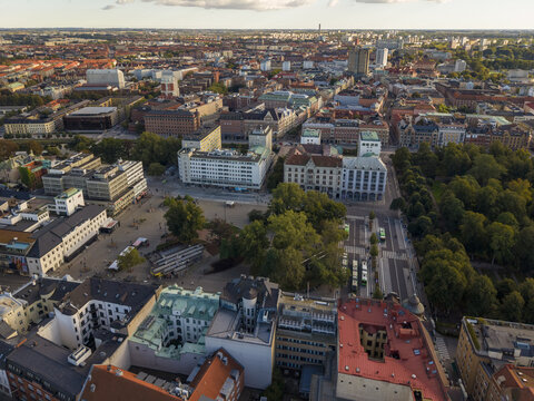 Aerial view of Gustav Adolfs torg square, a blend of modern architecture and green spaces under a soft sky, Malmo, Sweden.