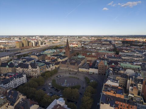 Aerial view of Stortorget square, Malmo Radhus standing tall, old buildings with their varied rooflines, and the distant cityscape fade into a tranquil skyline, Malmo, Malmo, Sweden.