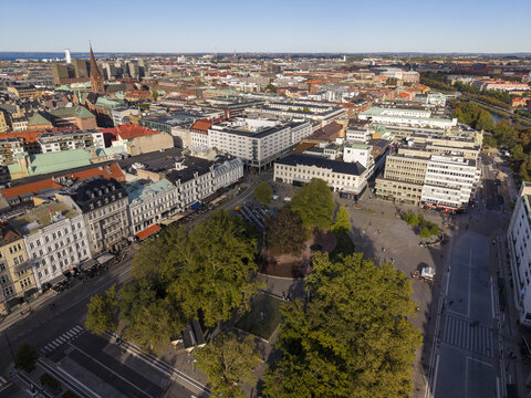 Aerial view of Gustav Adolfs torg with its mix of old and new buildings, trees casting shadows on the square, blending history and modernity., Malmo, Sweden.