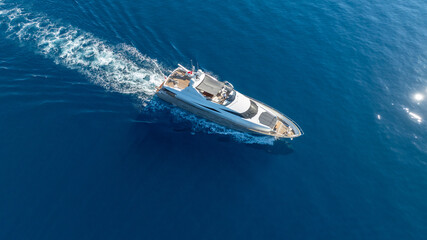 Captivating aerial view of a luxury yacht cutting through crystal waters.