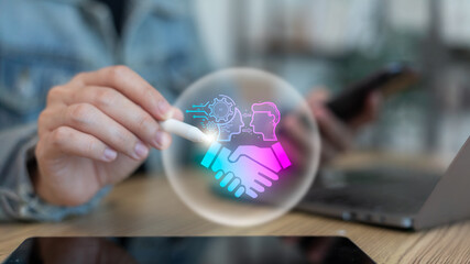 A person using a digital pen with a holographic handshake icon representing human and AI collaboration, artificial intelligence partnership, and futuristic business technology innovation.
