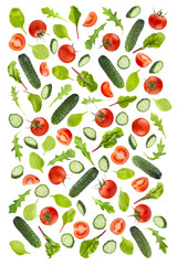 Fresh green salad of mix green vegetables, red tomatoes and leafy greens as flying pattern, isolated. Cucumber, ripe cherry tomato, lush green leaves of spinach, chard, arugula. Healthy organic food.