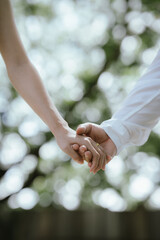 A close-up of a couple holding hands, symbolizing love, care, trust, and a romantic relationship with warmth and connection.