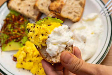 avocado, egg scramble and yogurt on a bread