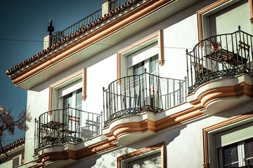 Selbstklebende Fototapeten Mediterranes Europa Elegant white building with decorative balconies and traditional Mediterranean design. Urban southern European vibe.  © Bartek