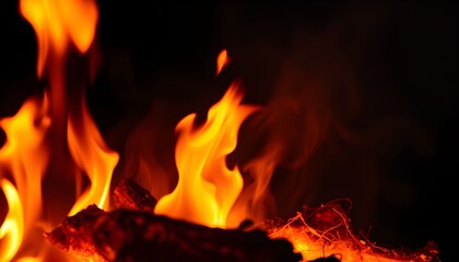 Close-up view of vibrant orange and yellow flames burning brightly in the dark.