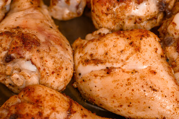 A close-up of the texture of roasted poultry meat, golden chicken drumsticks